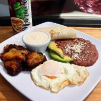Desayuno Tipico · Fried sweet plantain with beans, sour cream, egg, cheese, and 2 corn 
Platano y frijoles, cr...