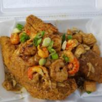 Voodoo Catfish · 2 catfish fillets over savory dirty rice topped with our signature Swamp Sauce w/sliced scal...