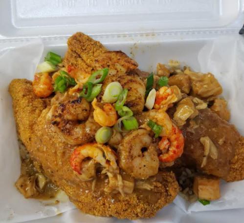 Voodoo Catfish · 2 catfish fillets over savory dirty rice topped with our signature Swamp Sauce w/sliced scallions