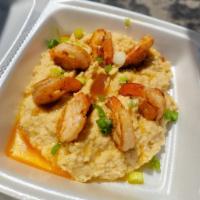 Shrimp and Grits · 7 jumbo cajun shrimp in a butter sauce over creamy cheese grits topped with sliced scallions