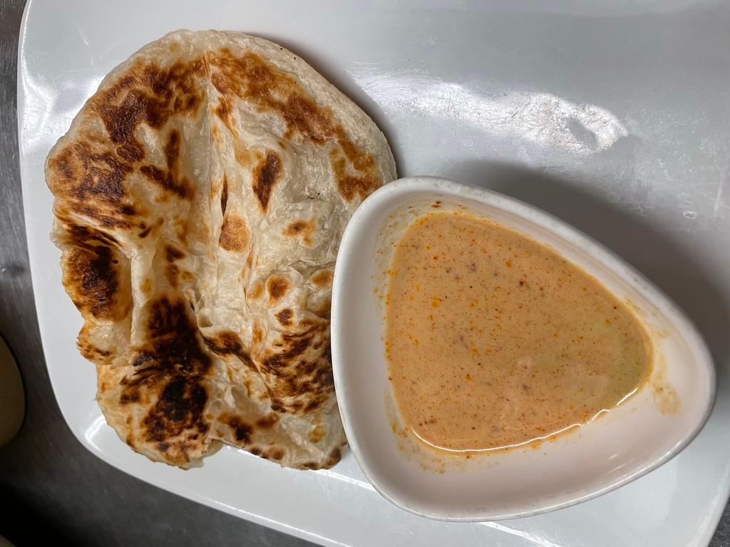 Roti Roti · Flat bread with a side of masaman curry.