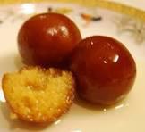 Gulab Jamun · A light pastry made from dry milk and flour and soaked in a thick sugary syrup. 