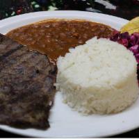 Carne Asada · Grilled steak. Rice, salad, beans and fried green plantains.