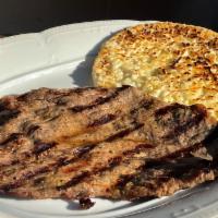 Carne Asada and Arepa Con Queso · Grilled steak and corn cake with cheese.