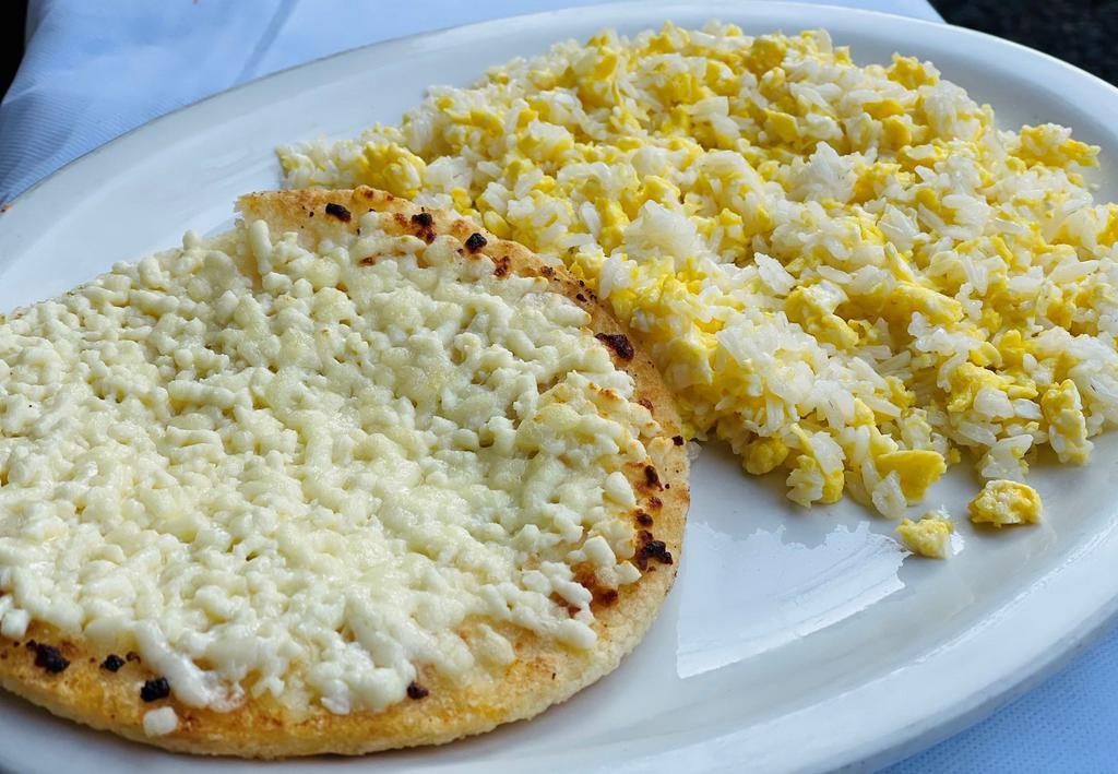 Arroz Revuelto con huevo y Arepa con Queso. · Arroz revuelto con huevo y arepa con queso
Rice mixed w/ scrambled eggs w/ arepa with cheese.
