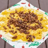 Beefy Quesadilla  · Good quality mixed American and Cheddar Cheese spreaded on a 13 inch warm flour tortilla fil...