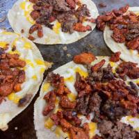 Tacos Campechanos  · 4 tacos: Each taco contains mixed meats of al pastor and beef steak which are grilled to per...