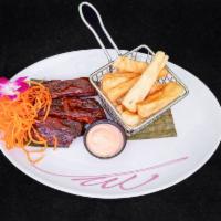 Baby Back Ribs · Slow-roasted ribs, BBQ guava sauce, yucca fries.