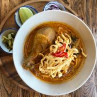 Chiang Mai Curry Noodle Soup · Northern Thai style noodles with slow braised chicken leg on the bone topped with pickled mu...