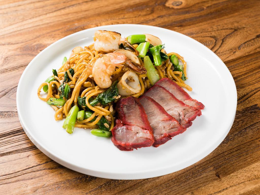Phuket Lo Mein · Southern style sauteed lo mein noodles, roasted pork, shrimp, squid, and Chinese broccoli with Thai yellow bean soy sauce.