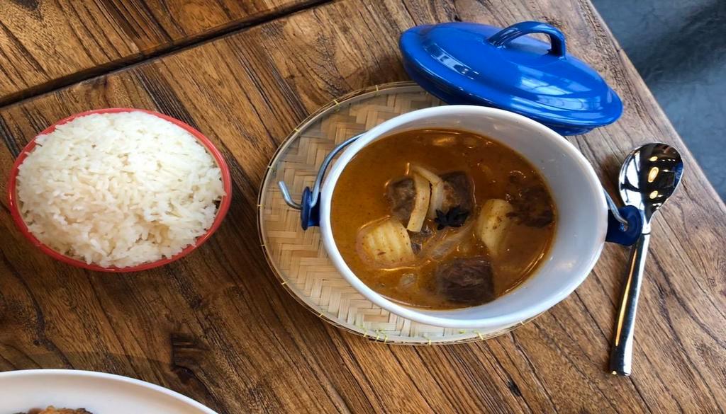 Massaman Curry (GF) · Slow braised beef, onions, potatoes, and peanuts with a creamy yellow coconut curry sauce, served with rice.