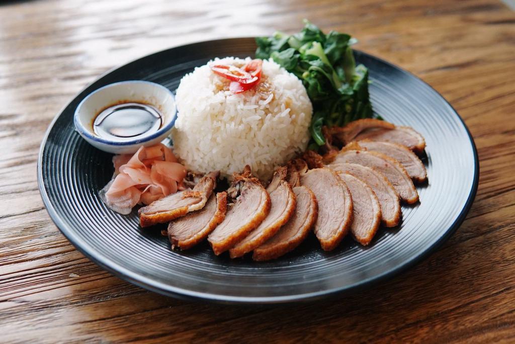 Duck over rice · crispy duck breast, chinese broccoli, pickled ginger with homemade soy vinaigrette 