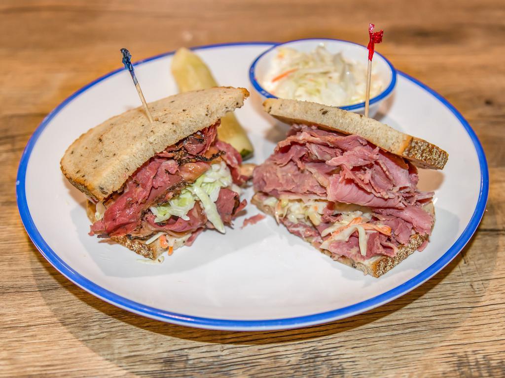 Brighton Sandwich · Can't decide today. How about one 1/2 corned beef and one 1/2 pastrami. Corned beef and pastrami with Russian and coleslaw on rye.