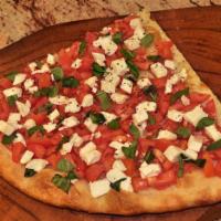 Capri Pizza · Diced tomatoes with basil, fresh mozzarella and extra virgin olive oil.