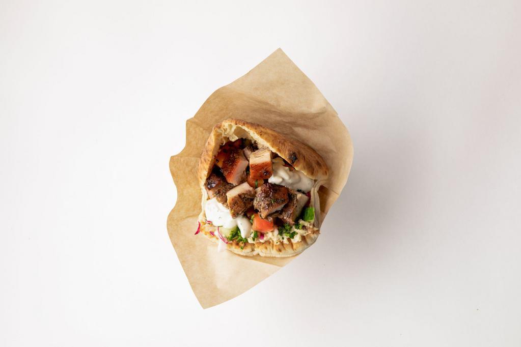 Roasted Chicken Pita · Slow roasted chicken marinated in mint, sumac and honey stuffed into a freshly baked pita pocket with hummus, israeli salad, pickled cabbage and tahini sauce.  Add toppings to customize it!  