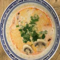 S2. Tom Kha Soup · Lightly seasoned coconut broth with mushrooms. Choice of shrimp or chicken or vegetables. Sp...