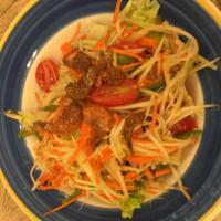 A4. Papaya Salad Plate · Fresh shredded papaya with peanuts, string beans, tomatoes and dry shrimps in a spicy lime d...