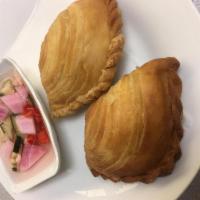 A11. Curry Puff Plate · Puff pastry stuffed with minced chicken and potatoes, seasoned with yellow curry and served ...