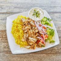 Chicken Shawarma Platter · Thinly sliced slow roasted chicken over rice, lettuce, pickles, and tahini sauce.