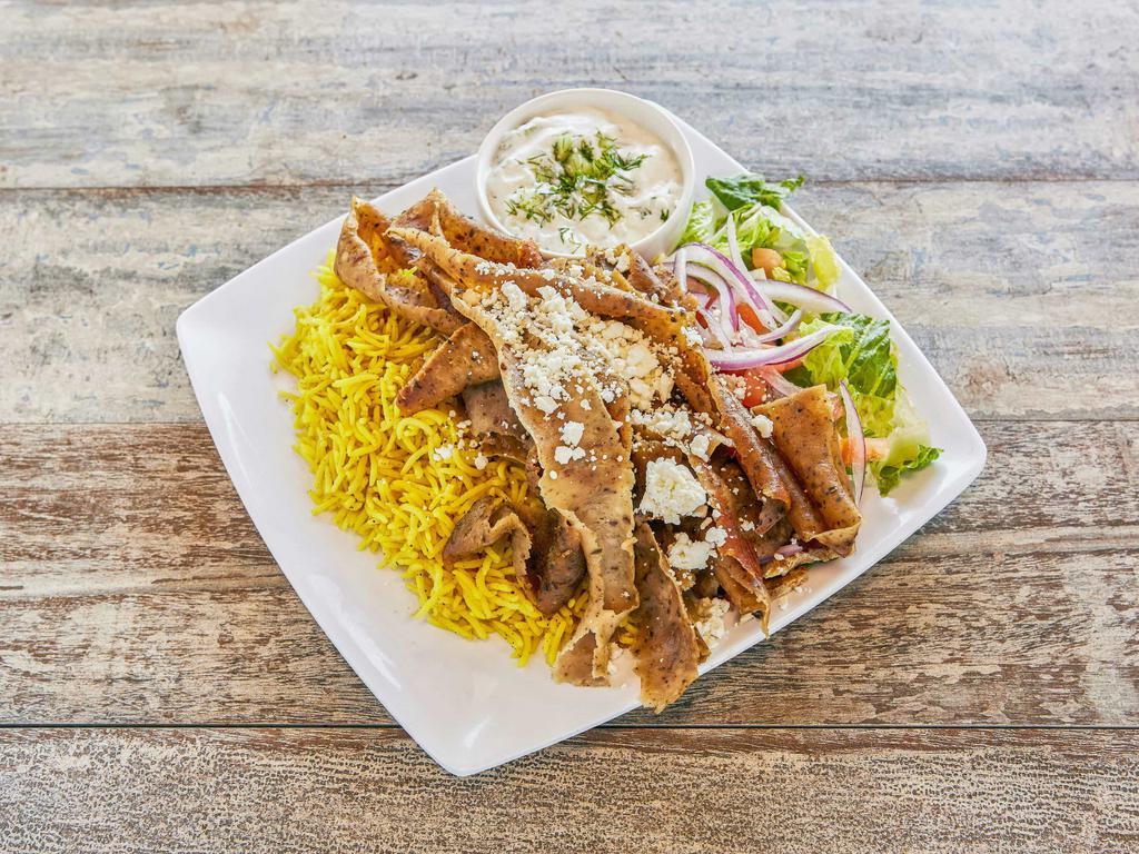 Gyro Platter · Thinly sliced beef and lamb over rice, red onion, pickles, lettuce, feta cheese, tomatoes, tahini sauce or tzatziki.