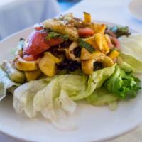 Dinner Goi Muc · Grilled calamari over cucumber, tomato, mixed greens, and fresh herbs.