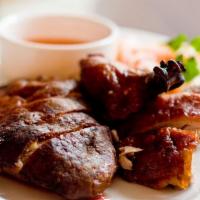 Dinner Vit Nuong · Roasted duck with lime ginger dipping sauce.