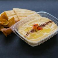 Hummus (Vegetarian) · Mashed chickpeas, blended with tahini, garlic, lemon juice and olive oil. Served with warm p...