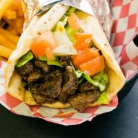 Beef Shawarma Sandwich · Marinated beef with special spices and lettuce, tomato topped with Tahini sauce.
