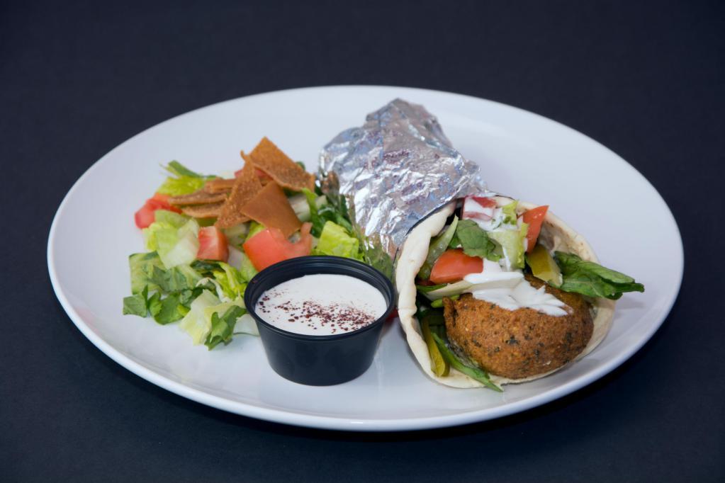 Falafel Sandwich (Vegetarian) · Deep-fried vegetable patties made with chickpeas and special spices. Served with lettuce, tomato, pickles and tahini sesame sauce. Served on pita bread.