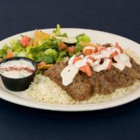 Grilled Gyro Platter · Seasoned grilled Lamb and Beef served over Basmati rice with Green salad and Tzatziki Sauce.