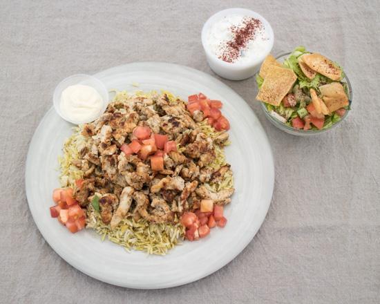 Grilled Chicken Shawarma Platter · Marinated and seasoned white breast chicken served over Basmati rice with Green salad and Tzatziki Sauce. HALAL Meat.  Creamy Garlic Sauce in a side container.