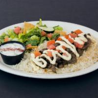 Grilled beef Shawarma Platter · Seasoned beef grilled and served over Basmati rice with Green salad and Tzatziki Sauce.