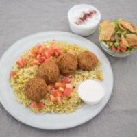 Falafel Platter over Rice Vegetarian · Deep fried vegetable patties made with chickpeas and spices. Served over Basmati rice with G...