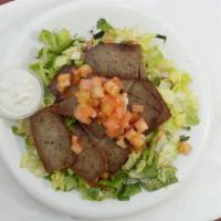 Lamb & Beef GYRO over Salad · Seasoned grilled Lamp and Beef served over Mixture of chopped  lettuce, tomatoes, cucumbers ...