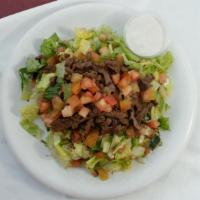Beef Shawarma over Salad · Marinated and seasoned Beef grilled served over mixture of chopped  lettuce, tomatoes, cucum...