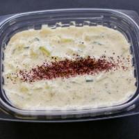 Tzatziki Sauce · Blended cucumber, yogurt, fresh garlic and dry mint.