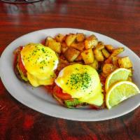 Eggs Benedict · Two poached eggs atop baked ham and an English muffin with Hollandaise sauce.