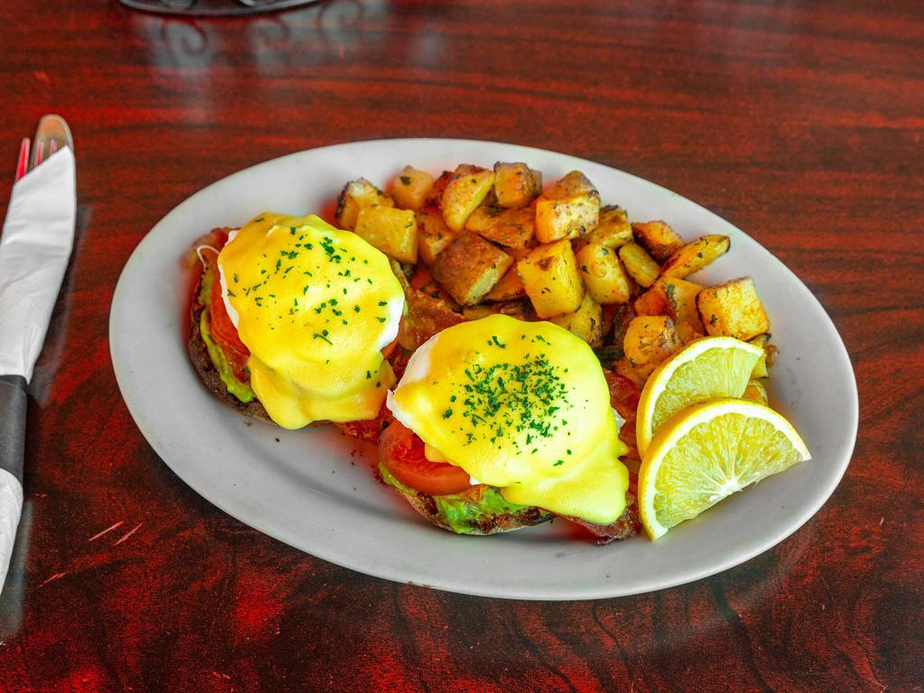 Eggs Benedict · Two poached eggs atop baked ham and an English muffin with Hollandaise sauce.