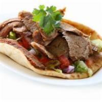 Lamb Gyro Sandwich · Grilled lamb sandwich with lettuce ,tomatoes and sauce served on a warm Pita bread.
