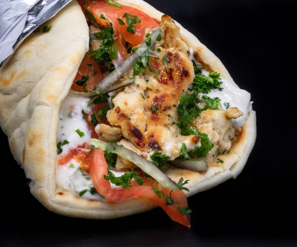 Gyro · Grilled lamb or grilled chicken served in a Greek pita with tzatziki, onion, parsley, and tomato.