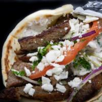 Super Gyro · Choice of lamb or chicken, served on warm pita with house tzatziki, ﬁnished with tomato, oni...