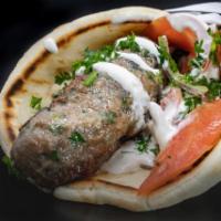 Kafta Kebab · Grilled skewers of seasoned ground beef, made daily, served in pita bread with lettuce, pars...