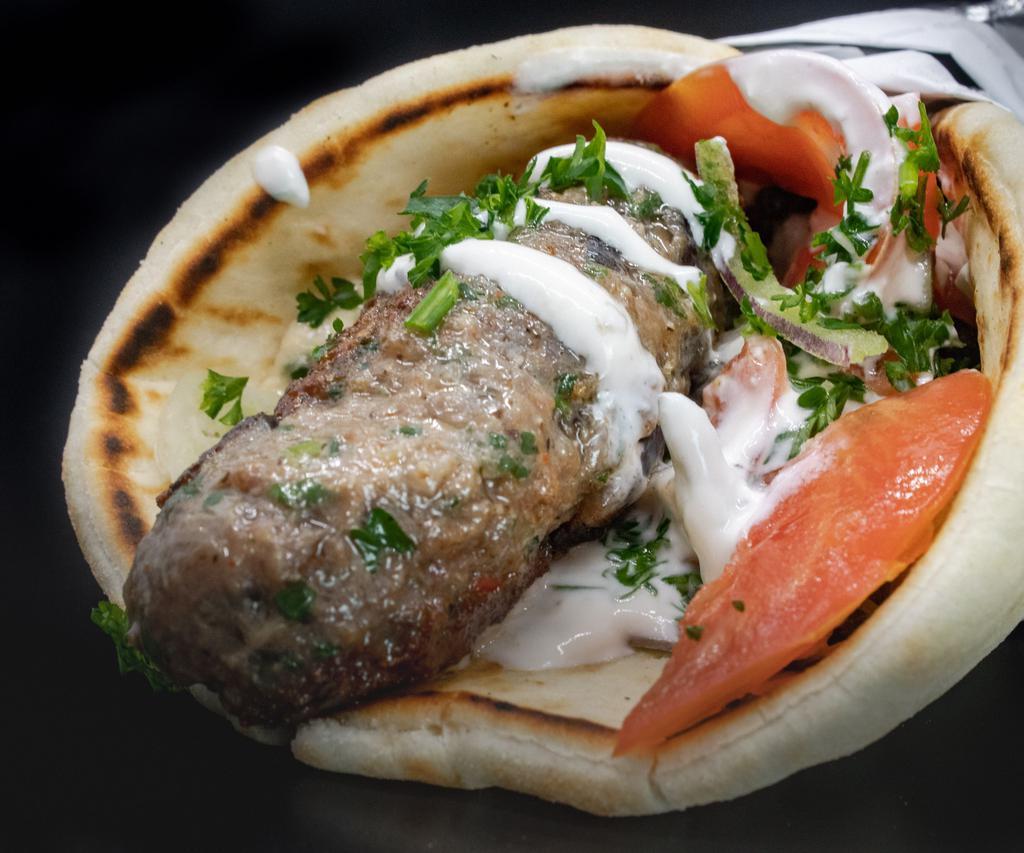 Kafta Kebab · Grilled skewers of seasoned ground beef, made daily, served in pita bread with lettuce, parsley, onion, and tomato. Your choice of tzatziki or tahini sauce.