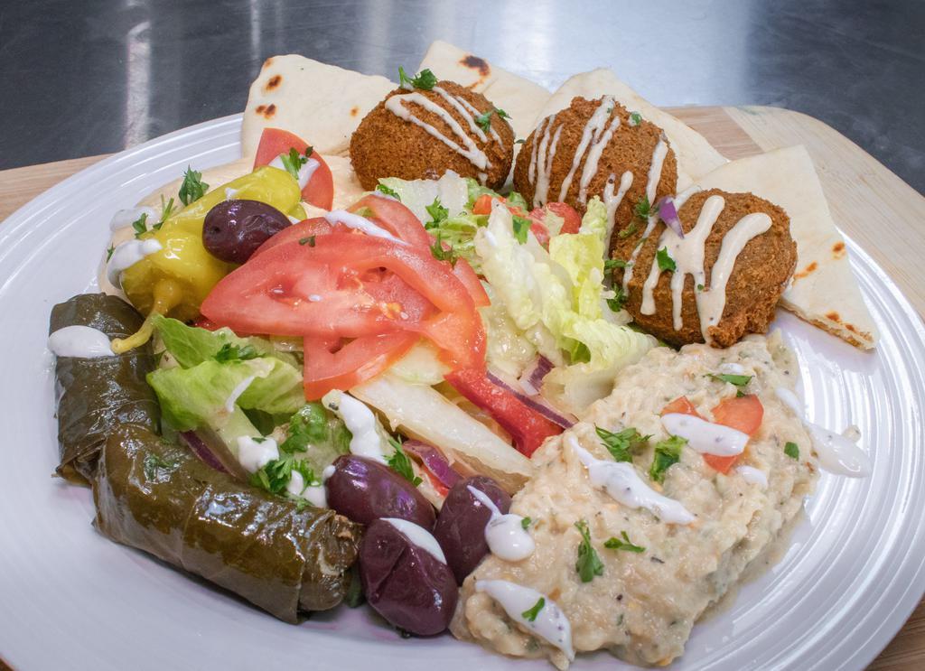 Veggie Mezza Plate · Falafel, hummus, dolmades, baba ghanouj and Greek salad, served with Greek pita.