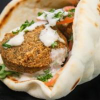 Falafel Sandwich · Delicious, golden falafel balls quickly deep fried. wrapped in a pita with hummus, tahini sa...