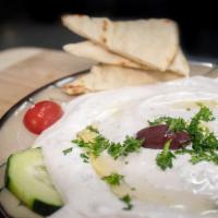 Tzatziki Plate served with warm pita · House made authentic Greek sauce with yogurt, extra virgin olive oil, oregano, cucumber, fre...