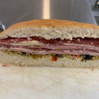 1/2 Muffaletta Sandwich · Bet you think that a half is too little, right? Well you might if you have never seen the si...