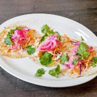 The Big Wave Fish Tacos · Pan seared cod, seasoned and seared to perfection, topped with creamy sriracha sauce, pickle...