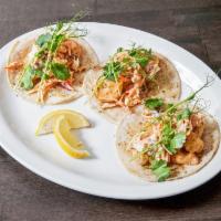 Hillbilly Rasta Shrimp Tacos · Large shrimp cooked in chili powder with spicy slaw and tiger sauce, topped with cilantro an...