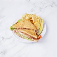 The Trapper Club · Oven-roasted turkey breast, melted cheddar cheese, bacon, tomato, lettuce and garlic mayo on...